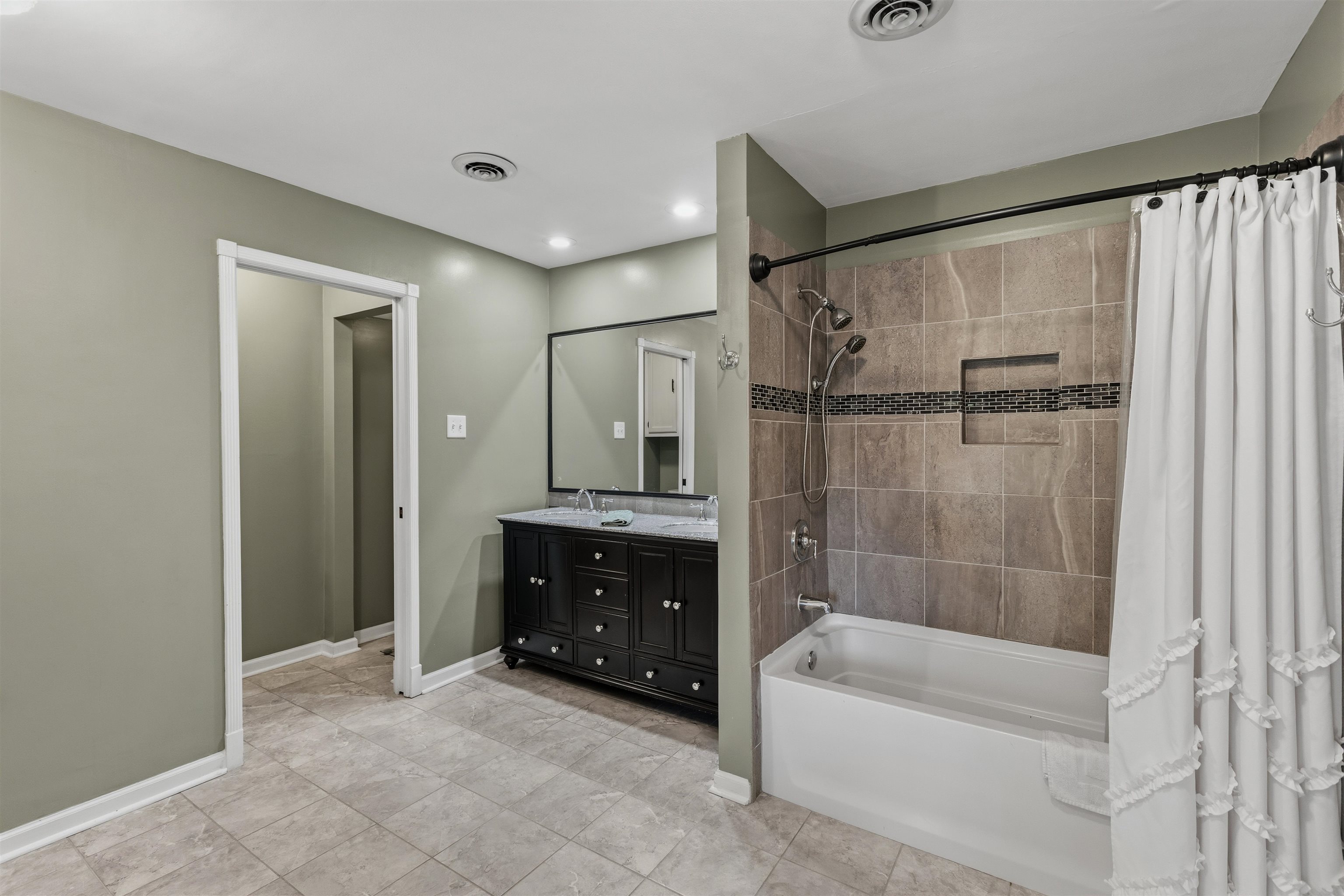 115 West Powell Road Collierville, TN 38017 - Photo 9 of 17 a bathroom with a bathtub and a shower