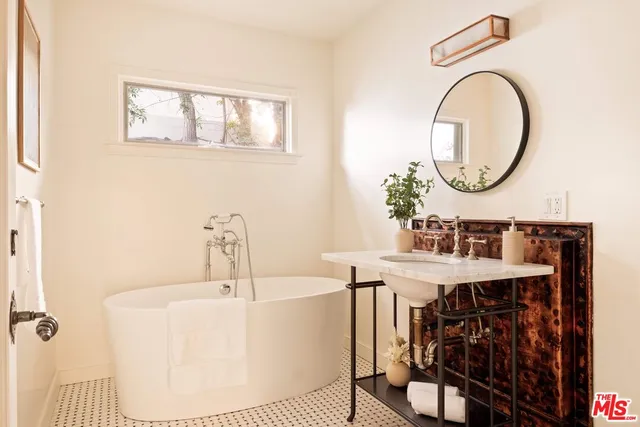 a bedroom with furniture and a window