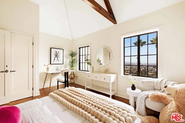 a view of a workspace with furniture and wooden floor