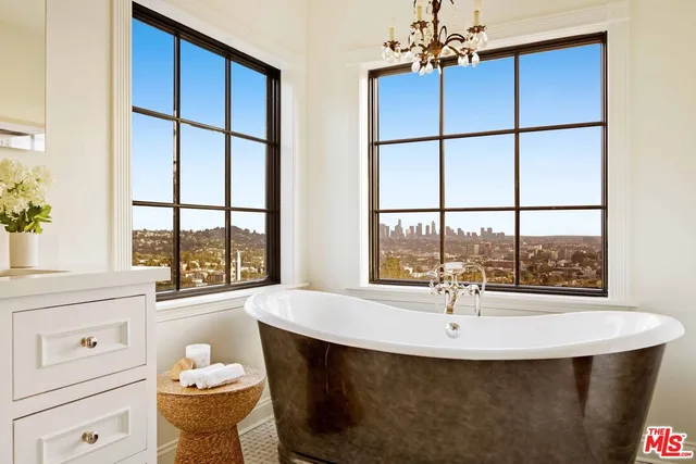 a spacious bathroom with a shower a sink and a mirror
