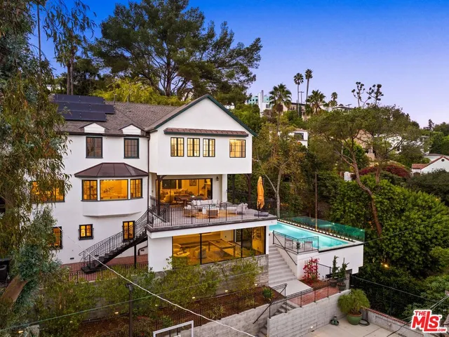 a view of a patio with table and chairs and potted plants