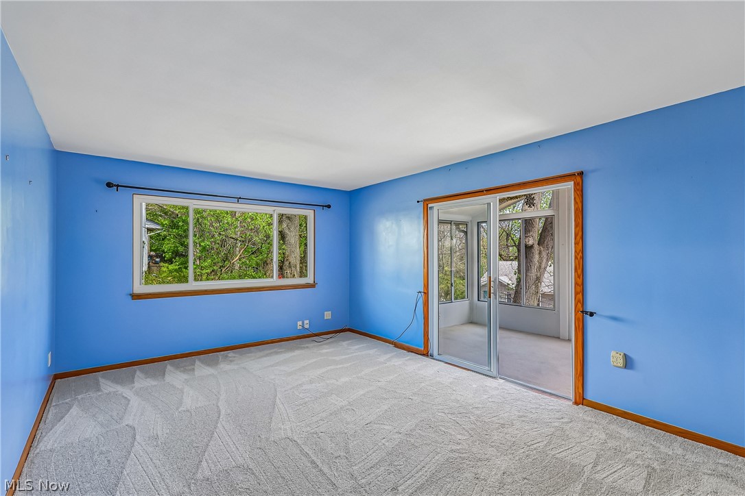 2060 6th Street Southwest Akron, OH 44314 - Photo 7 of 46 Living room with large picture window, sliding glass door to sun room and carpet flooring