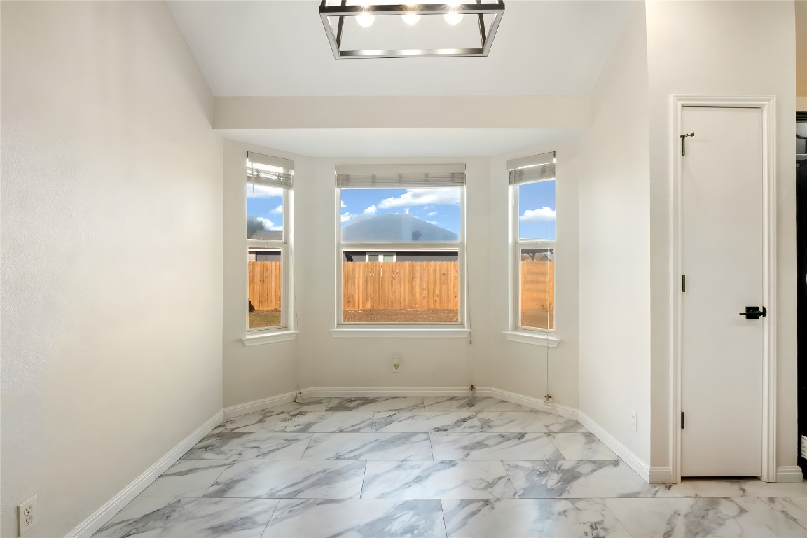 167 Hay Meadow Road Cedar Creek, TX 78612 - Photo 11 of 39 Dining area featuring tile flooring, vaulted ceiling, and recessed lighting