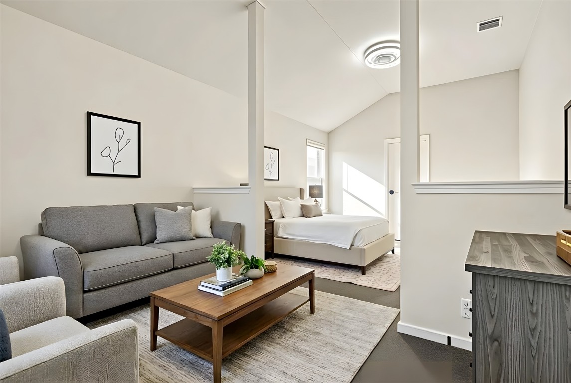 167 Hay Meadow Road Cedar Creek, TX 78612 - Photo 15 of 39 Virtually staged - Primary bedroom featuring vaulted ceiling and dark carpet
