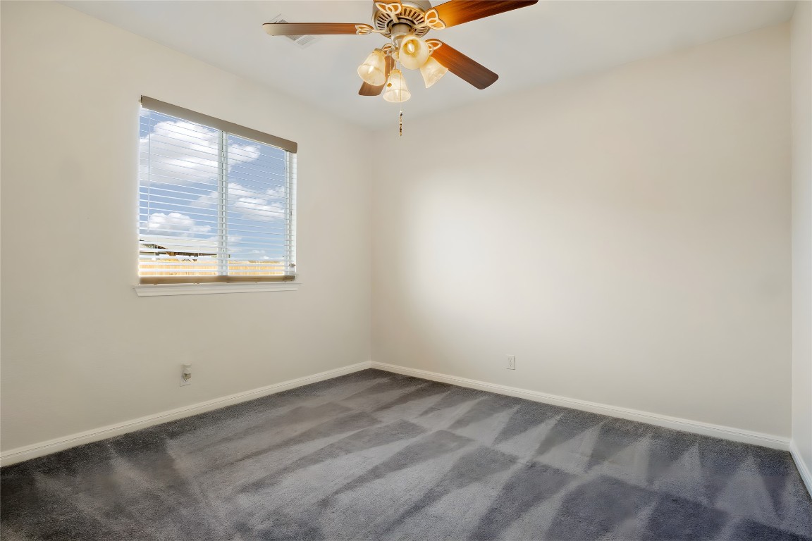 167 Hay Meadow Road Cedar Creek, TX 78612 - Photo 26 of 39 Bedroom #3 featuring a ceiling fan, dark carpet and a ceiling fan