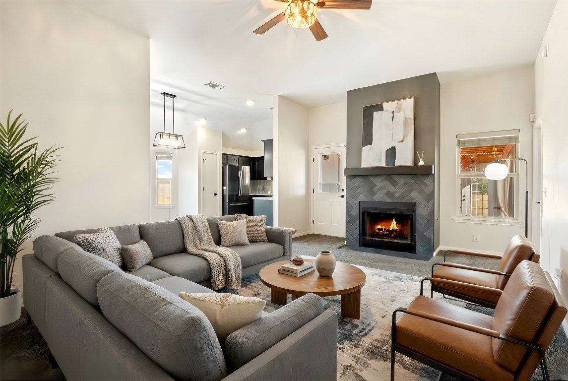 167 Hay Meadow Road Cedar Creek, TX 78612 - Photo 4 of 39 Virtually staged - Living room featuring a tile fireplace, dark carpet and ceiling fan