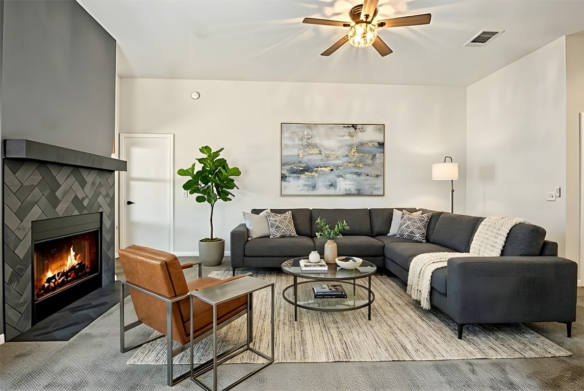 167 Hay Meadow Road Cedar Creek, TX 78612 - Photo 6 of 39 Virtually staged - Living room featuring a tile fireplace, dark carpet and ceiling fan