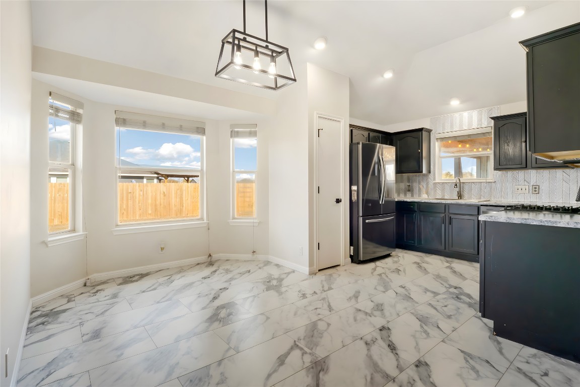 167 Hay Meadow Road Cedar Creek, TX 78612 - Photo 9 of 39 Dining area featuring tile flooring, vaulted ceiling, and recessed lighting