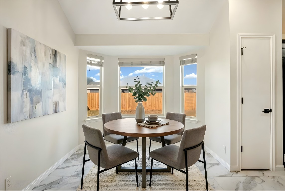 167 Hay Meadow Road Cedar Creek, TX 78612 - Photo 10 of 39 Virtually staged - Dining area featuring tile flooring, vaulted ceiling, and recessed lighting