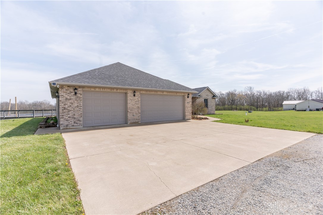 5264 Frazier-Guy Road Sidney, OH 45365 - Photo 2 of 51 This residence features a spacious three-car garage and a wide concrete driveway.