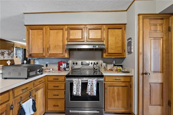 a kitchen with stainless steel appliances granite countertop a stove and a refrigerator