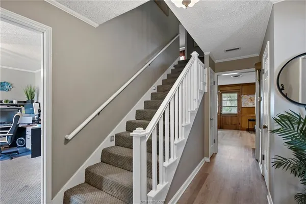 a view of entryway and hall with wooden floor