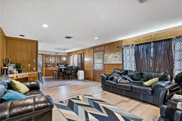 a living room with furniture and large window