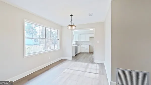 a view of a room with windows and entryway