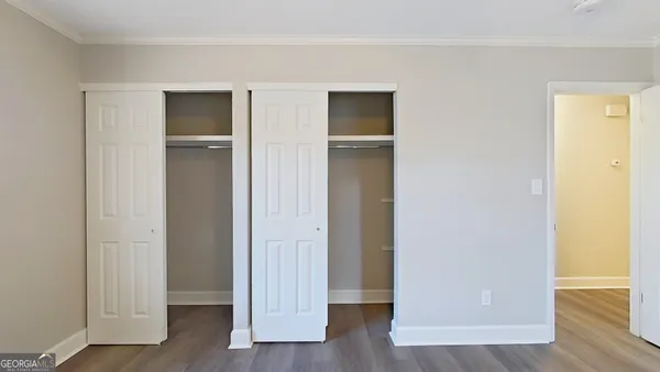a view of empty room with wooden floor