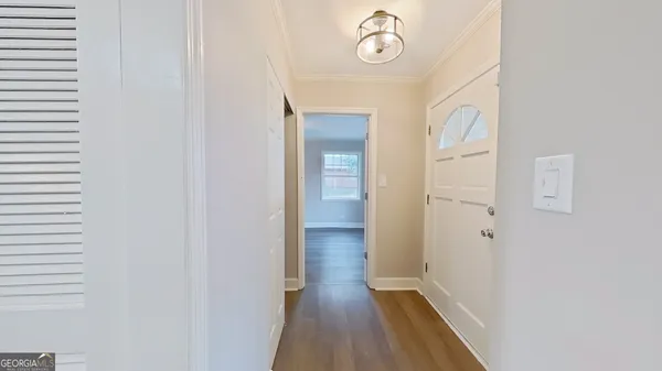 a view of a hallway with wooden floor