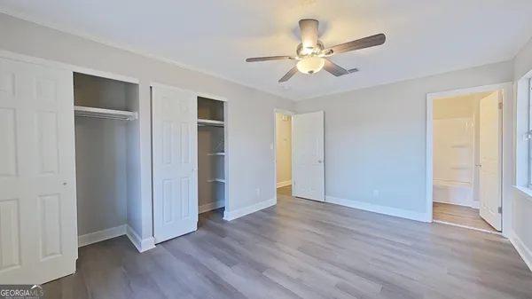 a view of an empty room with wooden floor