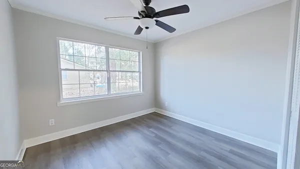wooden floor in an empty room with a window