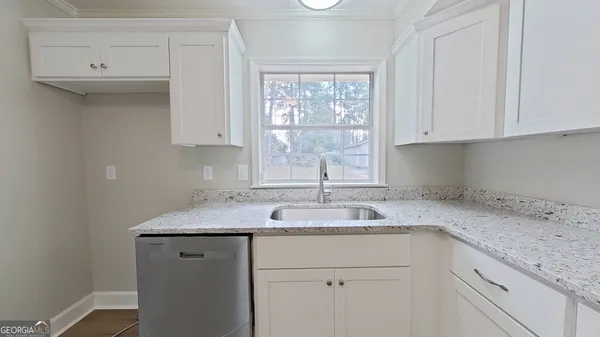 a kitchen with a sink cabinets and window