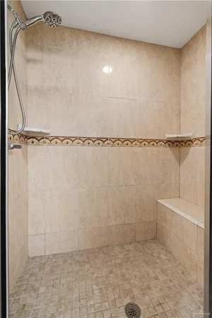 a bathroom with a glass shower door