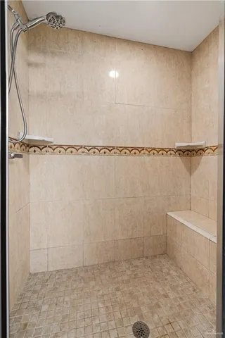 a bathroom with a glass shower door