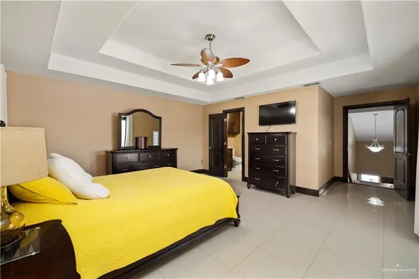 a bedroom with a bed and a chandelier