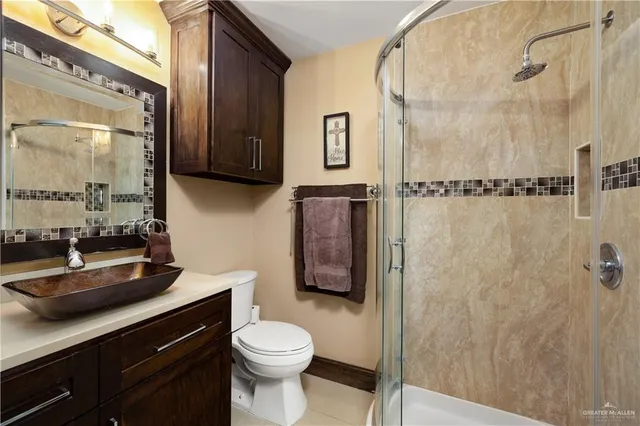a bathroom with a toilet sink and shower