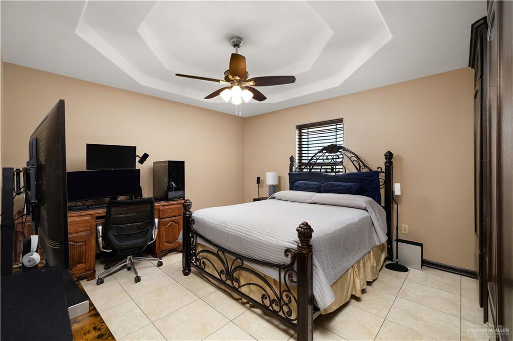 1257 Riverside Street Rio Grande City, TX 78582 - Photo 16 of 28 a bedroom with a bed and a flat tv screen on the dresser