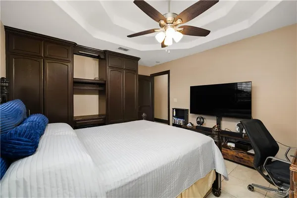 a bedroom with a bed and a flat screen tv