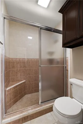 a bathroom with a shower and a toilet