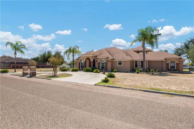 a front view of a house with a yard and a garage