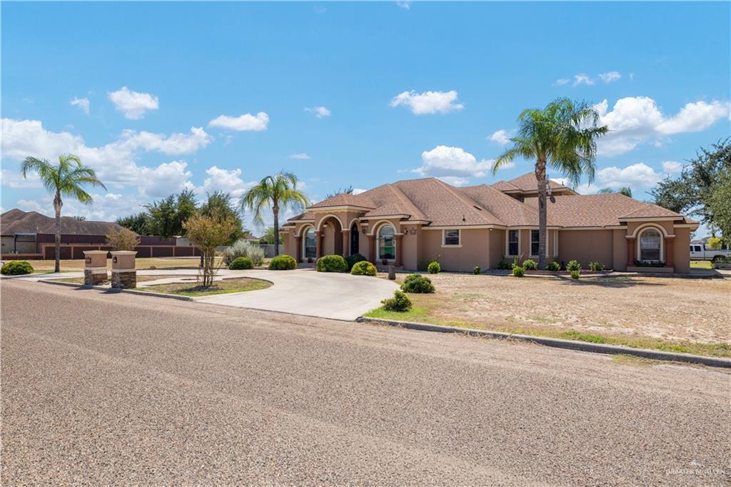 1257 Riverside Street Rio Grande City, TX 78582 - Photo 2 of 28 a front view of a house with a yard and a garage