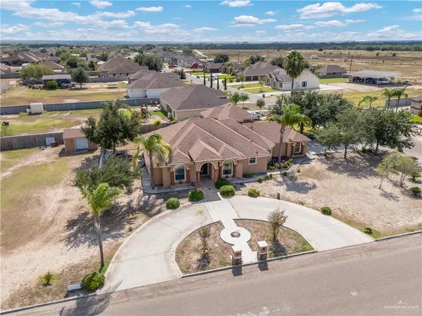 an aerial view of a house with a swimming pool