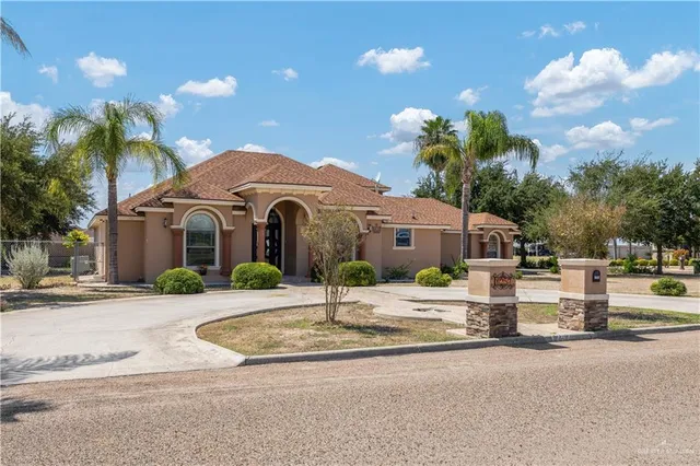 a front view of a house with a garden and a yard