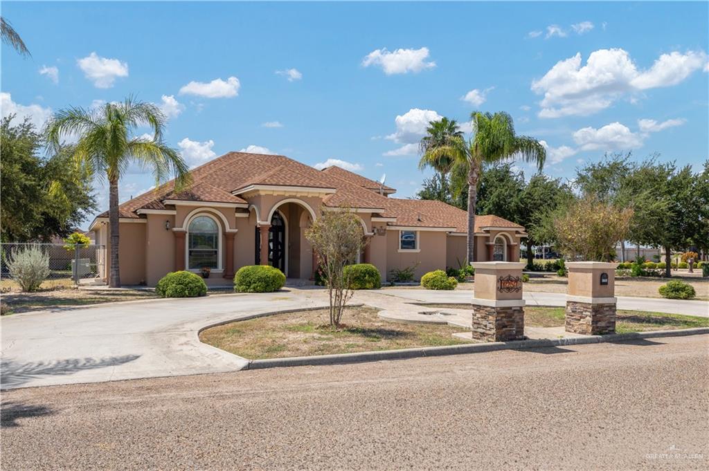 1257 Riverside Street Rio Grande City, TX 78582 - Photo 3 of 28 a front view of a house with a garden and a yard