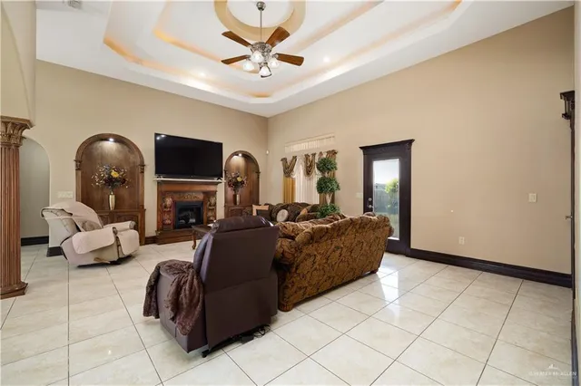 a living room with fireplace furniture and a chandelier