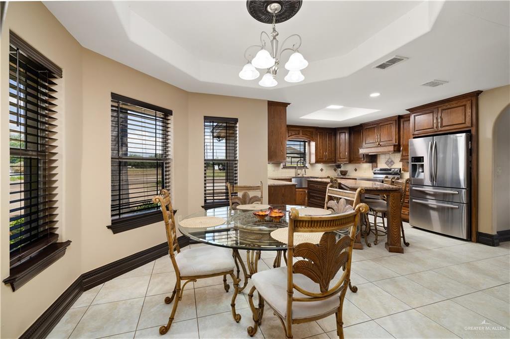 1257 Riverside Street Rio Grande City, TX 78582 - Photo 9 of 28 a view of a dining room with furniture and a chandelier