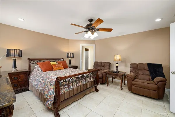 a bedroom with bed couch and window