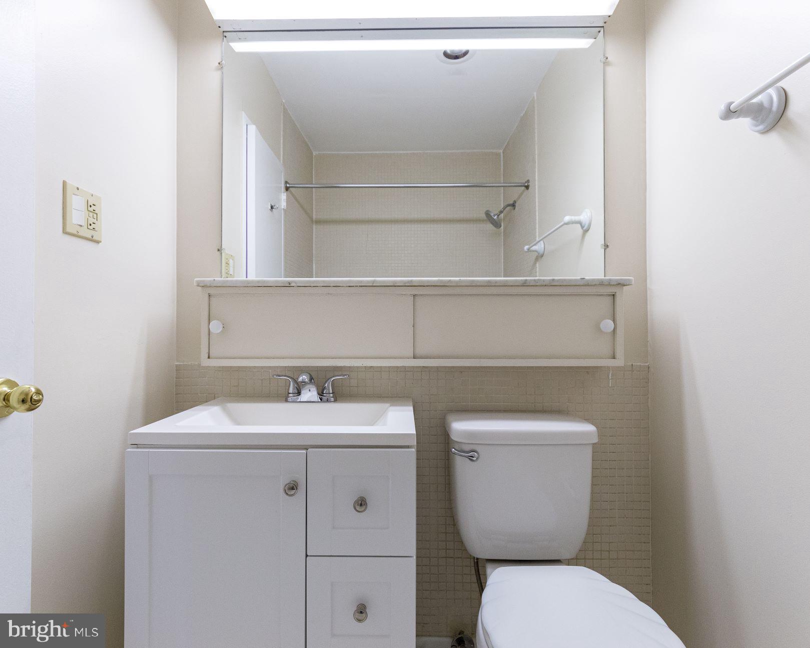 204 M Street Southwest, Unit 34 Washington, DC 20024 - Photo 18 of 28 a bathroom with a toilet sink and mirror