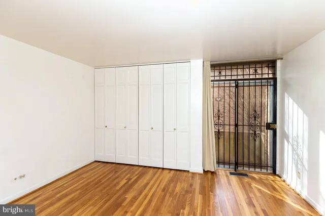 a view of a room with wooden floor