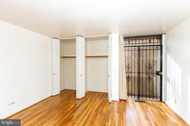 a view of a room with wooden floor and a window