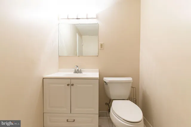 a white toilet sitting next to a bathroom sink