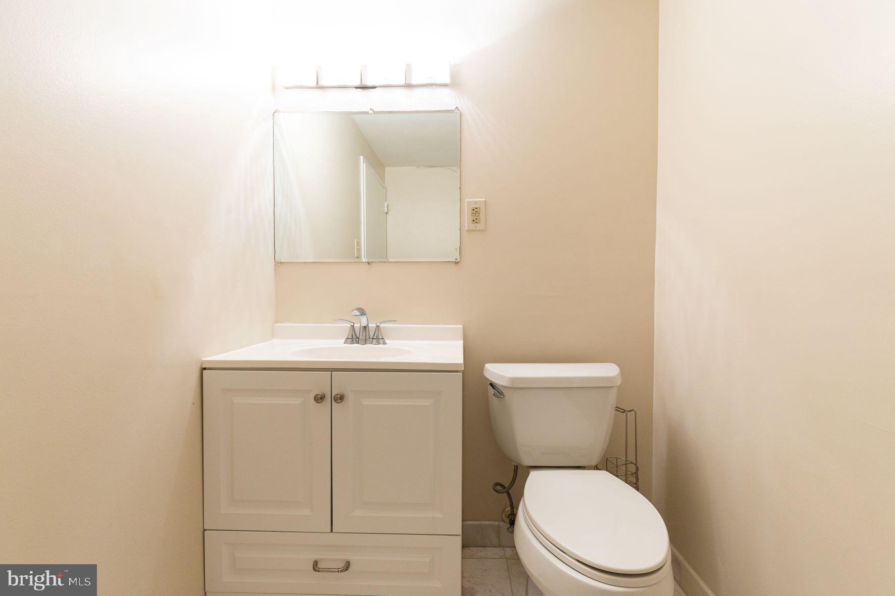 204 M Street Southwest, Unit 34 Washington, DC 20024 - Photo 26 of 28 a white toilet sitting next to a bathroom sink