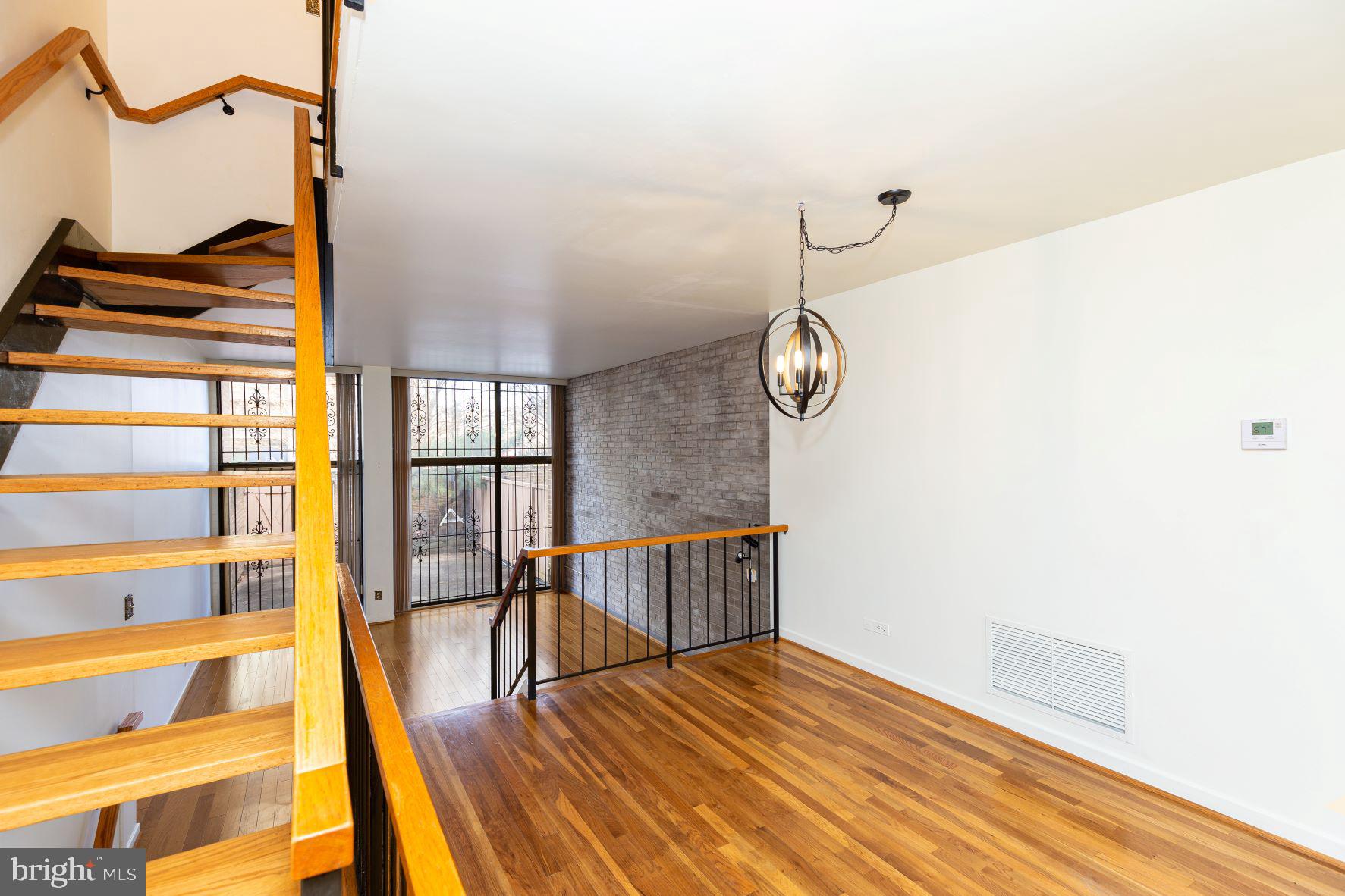 204 M Street Southwest, Unit 34 Washington, DC 20024 - Photo 10 of 28 a view of a bedroom with wooden floor and a window