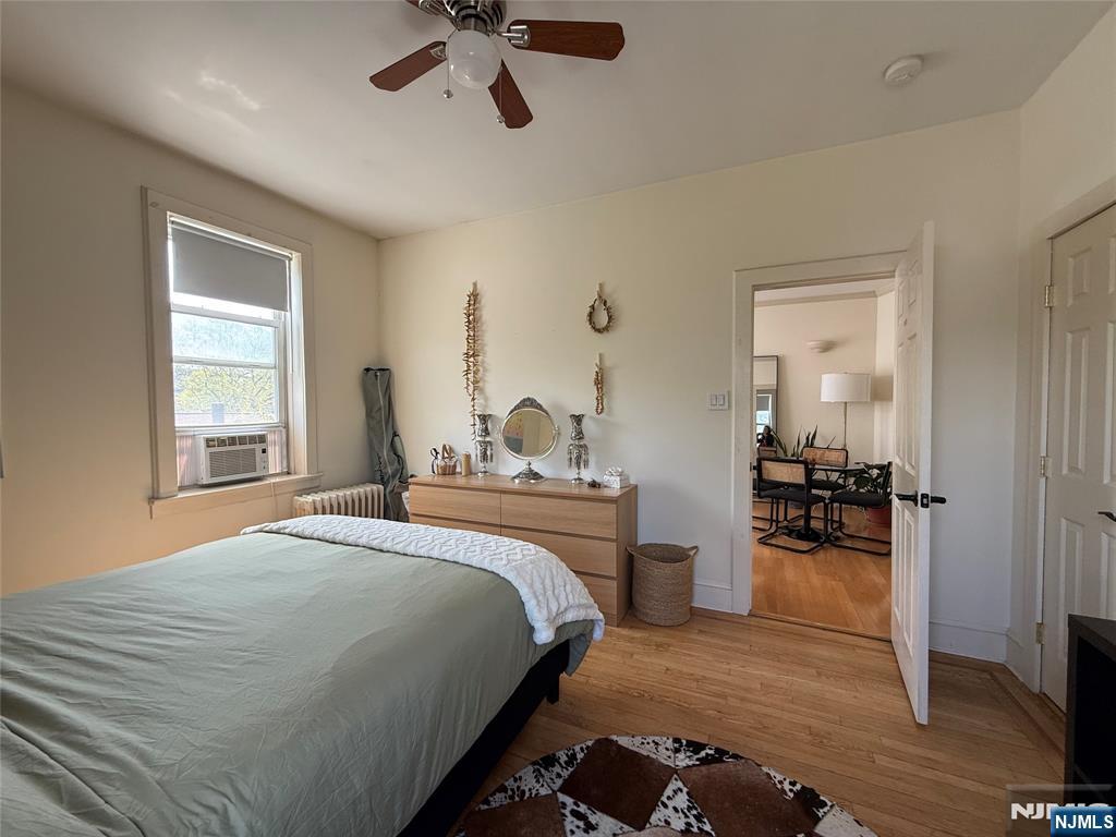 215 Orient Way, Unit C2 Rutherford, NJ 07070 - Photo 16 of 25 a bedroom with a bed and large windows