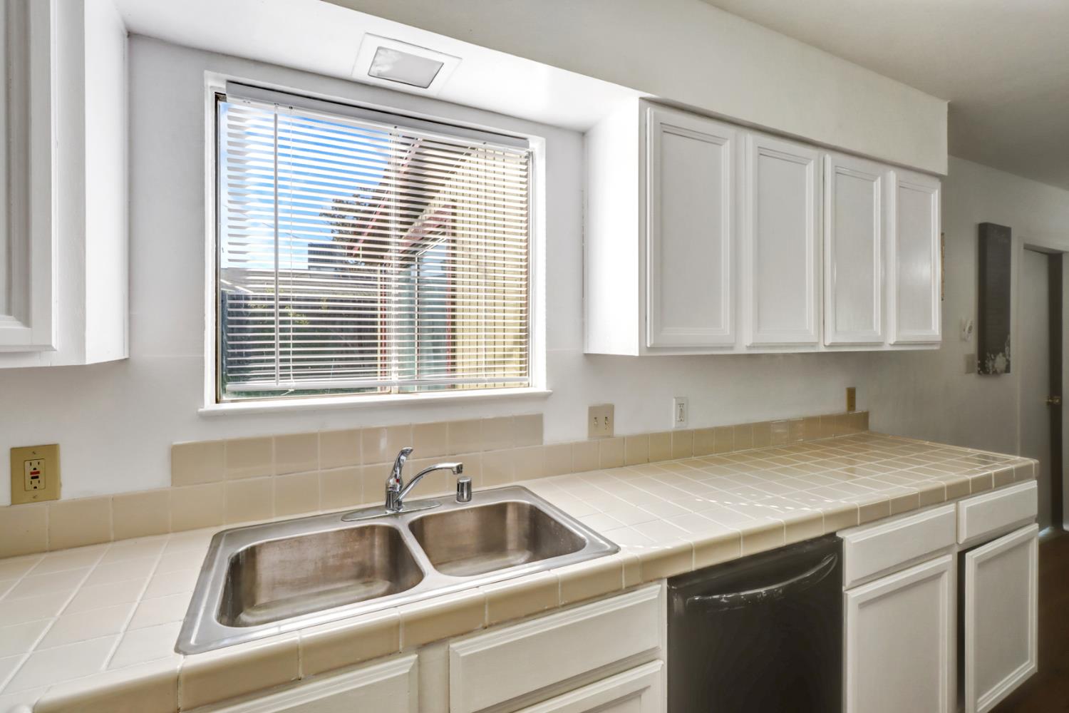 10556 Olson Drive Rancho Cordova, CA 95670 - Photo 18 of 46 a view with granite countertop a sink and a white cabinets