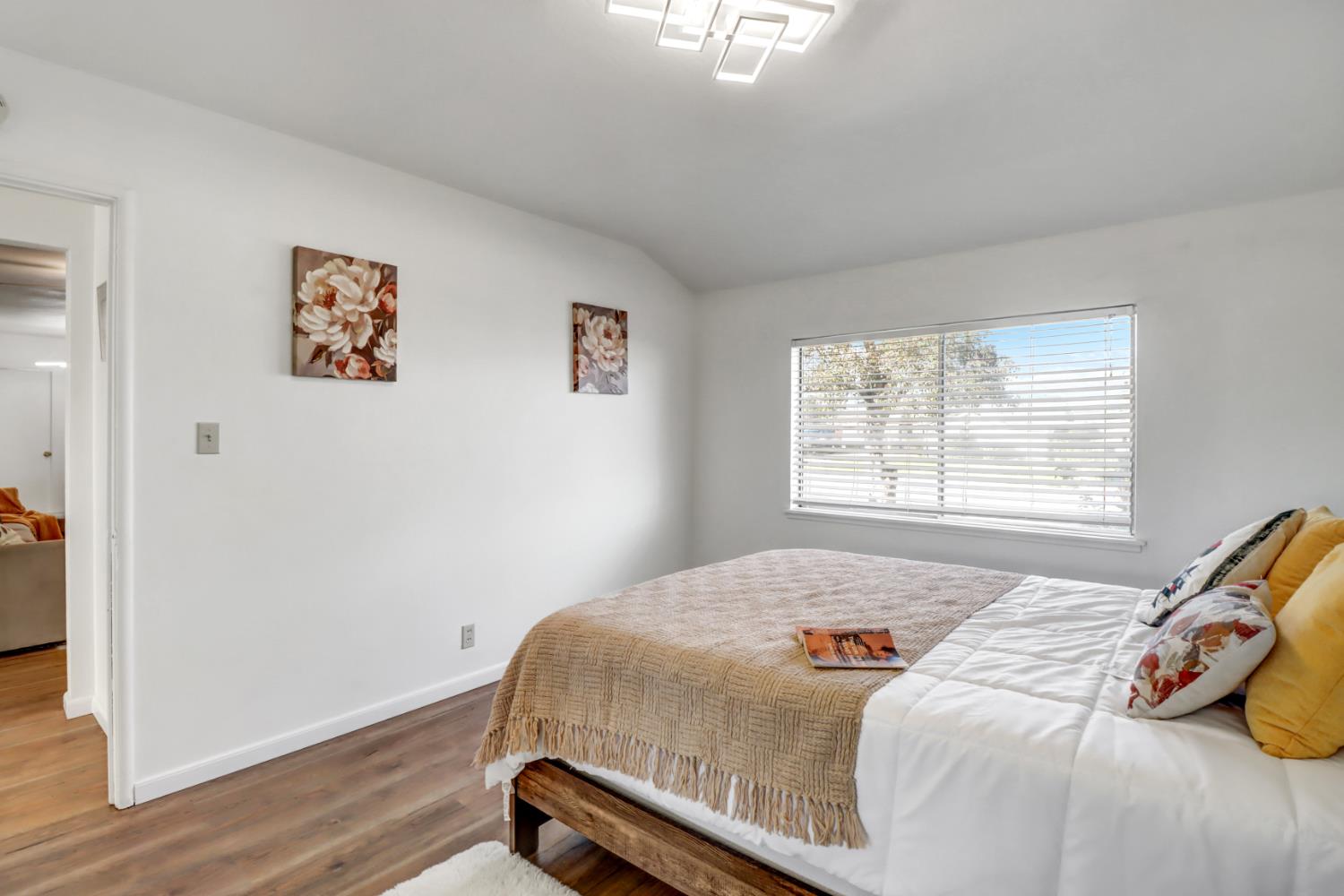 10556 Olson Drive Rancho Cordova, CA 95670 - Photo 25 of 46 a bedroom with a bed and wooden floor