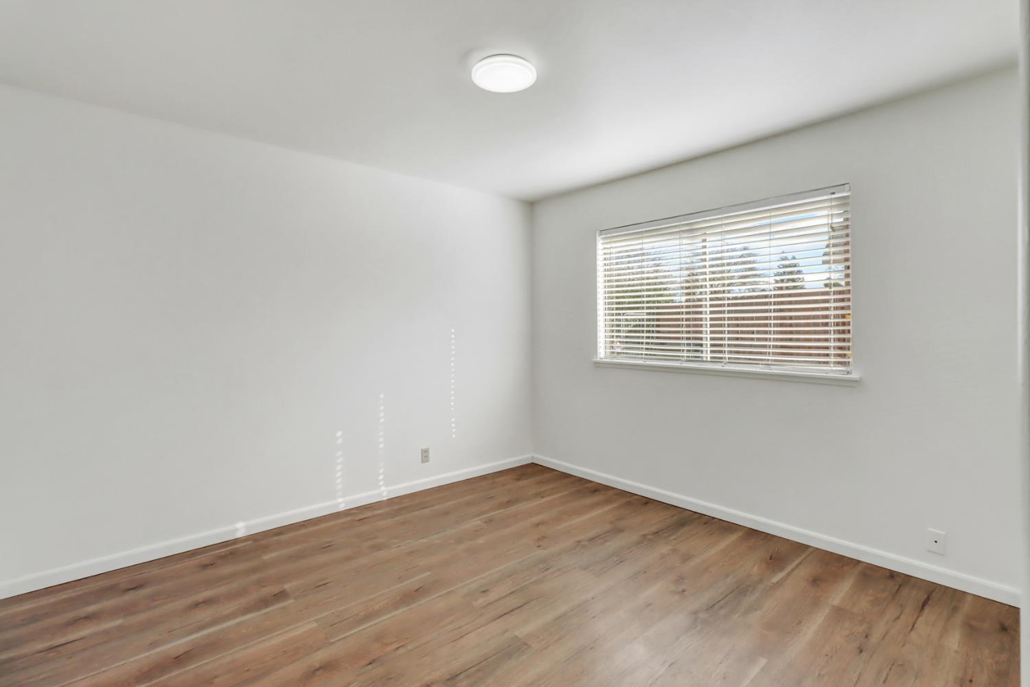 10556 Olson Drive Rancho Cordova, CA 95670 - Photo 27 of 46 wooden floor in an empty room with a window