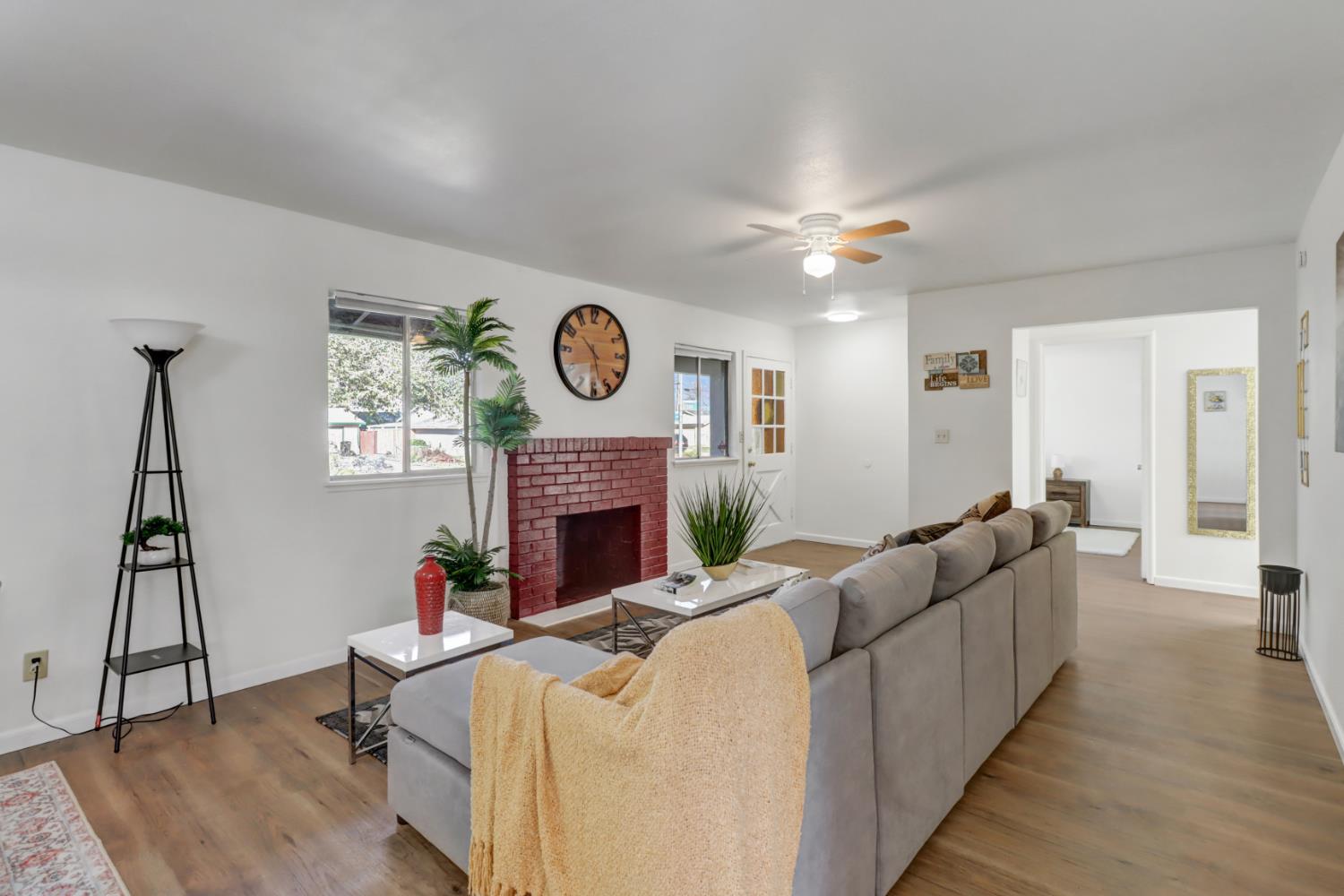 10556 Olson Drive Rancho Cordova, CA 95670 - Photo 8 of 46 a living room with furniture a clock and a fireplace