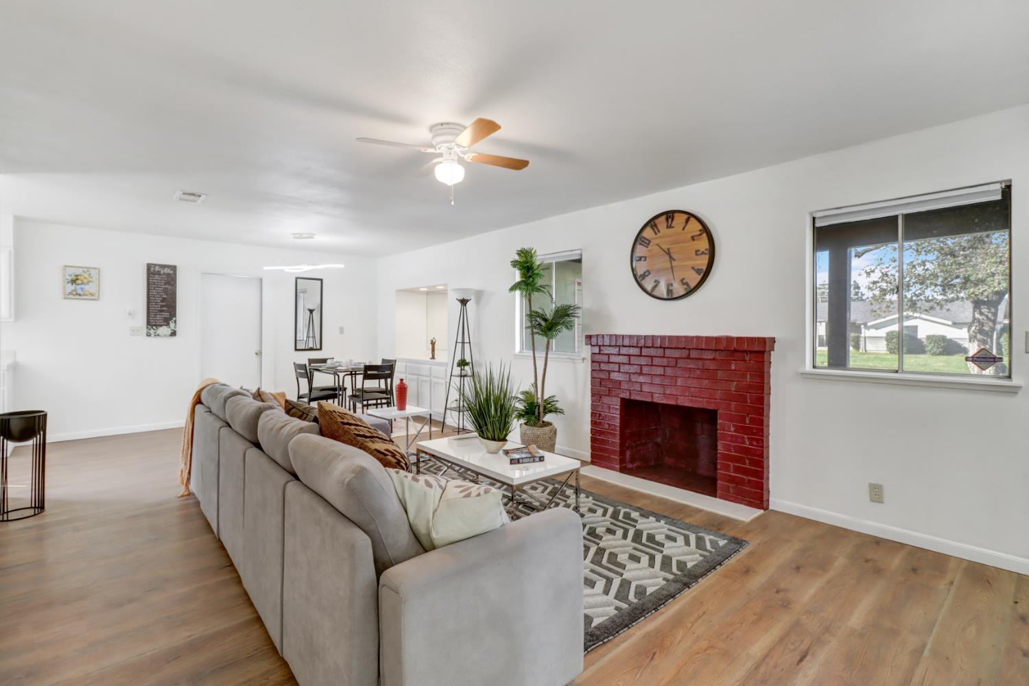 10556 Olson Drive Rancho Cordova, CA 95670 - Photo 10 of 46 a living room with furniture a fireplace and a large window